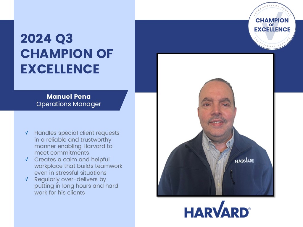 Man smiling in a HARVARD jacket, named 2024 Q3 Champion of Excellence for outstanding work.
