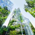 Tall glass buildings reflecting green trees under a clear blue sky, blending urban and natural elements.