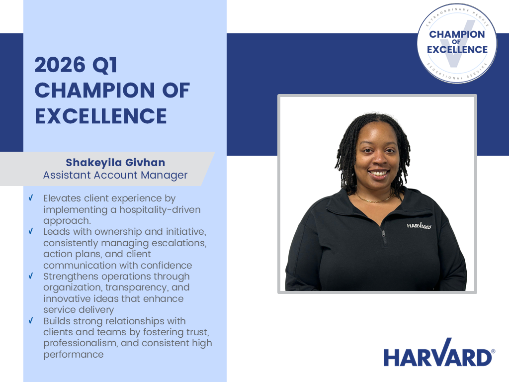 Shakeyila Givhan, Champion of Excellence awardee, stands smiling in front of a plain background.